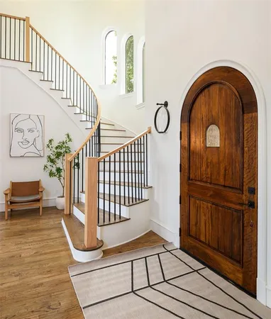 a dining room with furniture entryway and wooden floor