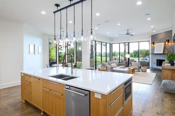 a living room with furniture fireplace and large windows