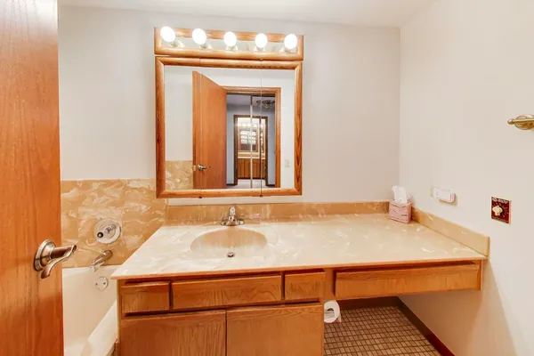 a bathroom with a sink and a mirror