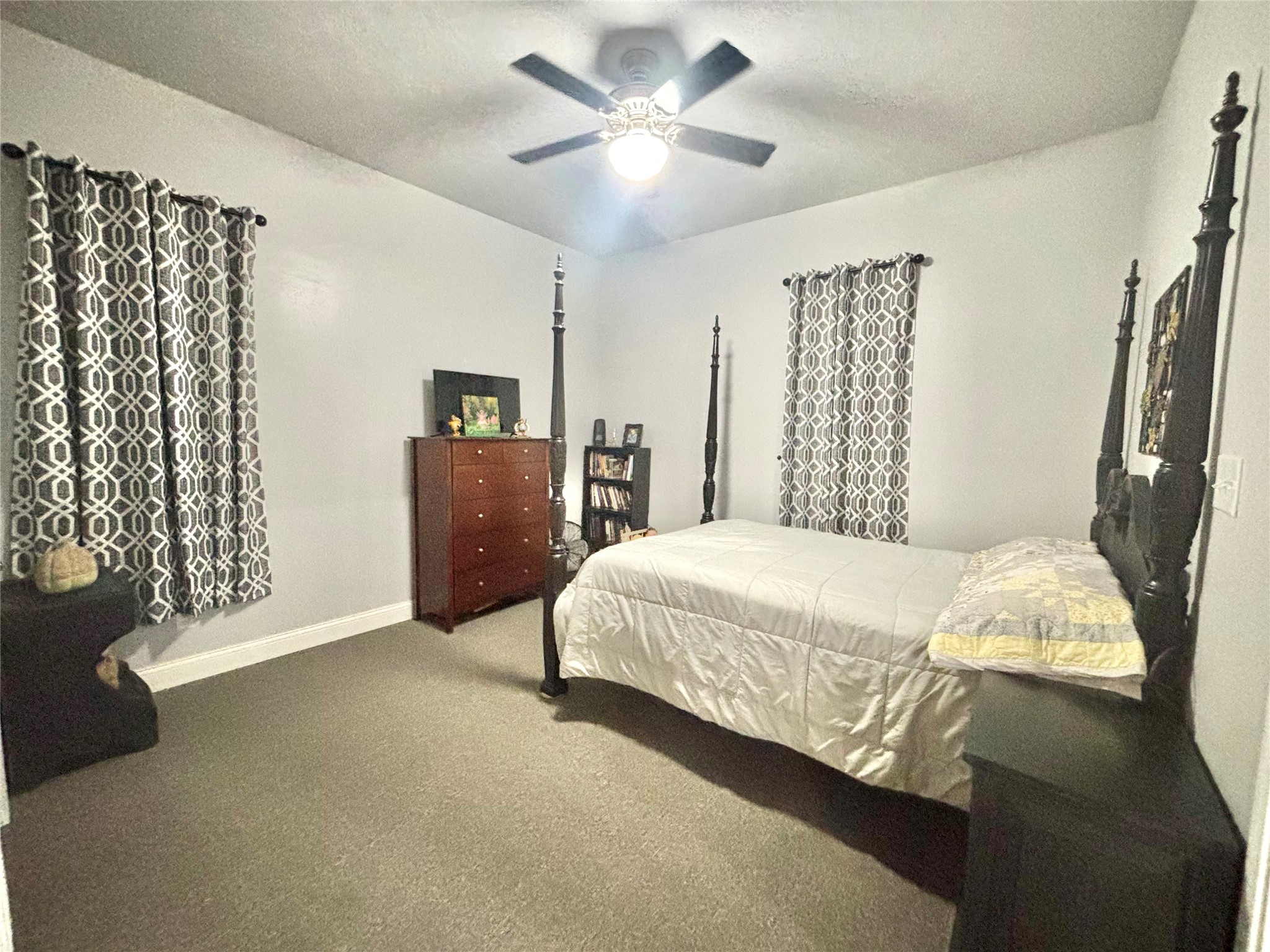 516 County Road 4800 Warren, TX 77664 - Photo 22 of 50 a bedroom with a bed and a chandelier