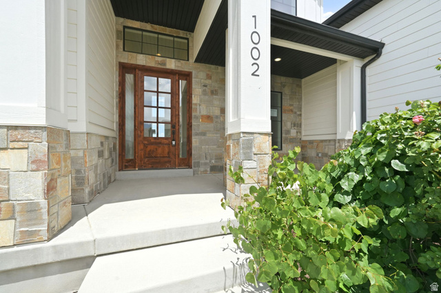 1002 West Temple Rim Lane Payson, UT 84651 - Photo 5 of 68 Crafted wood-paneled entry door with glass inserts and transom window
