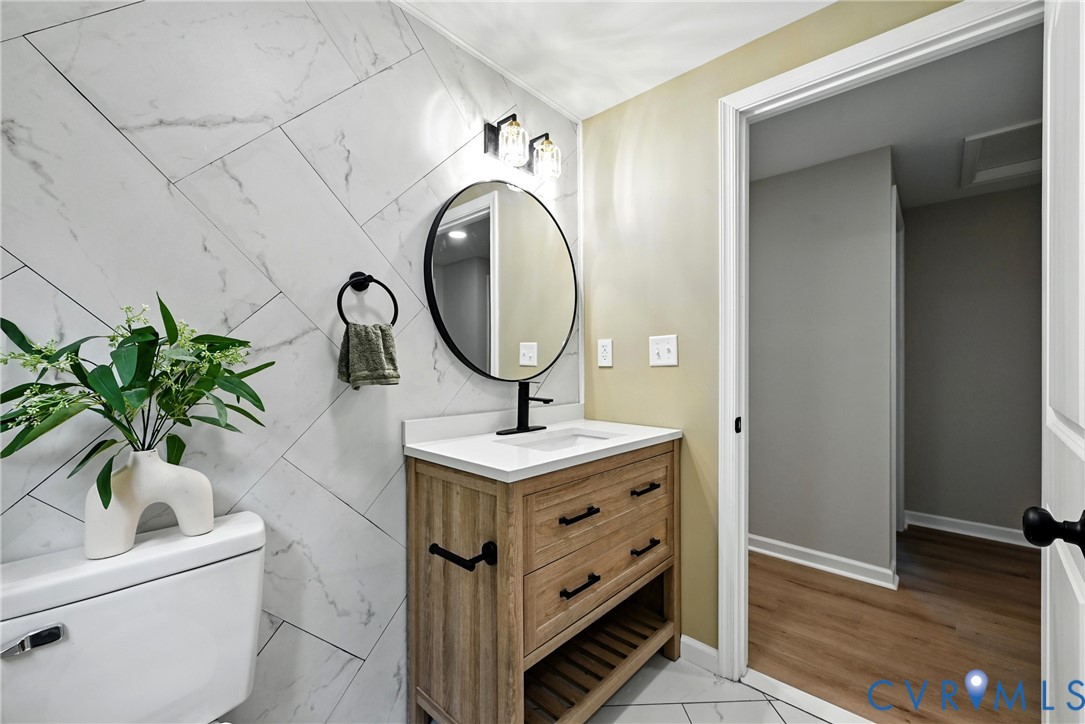 24611 Williamson Road Dinwiddie, VA 23841 - Photo 14 of 34 Bathroom with vanity, tile walls, and tile pattern