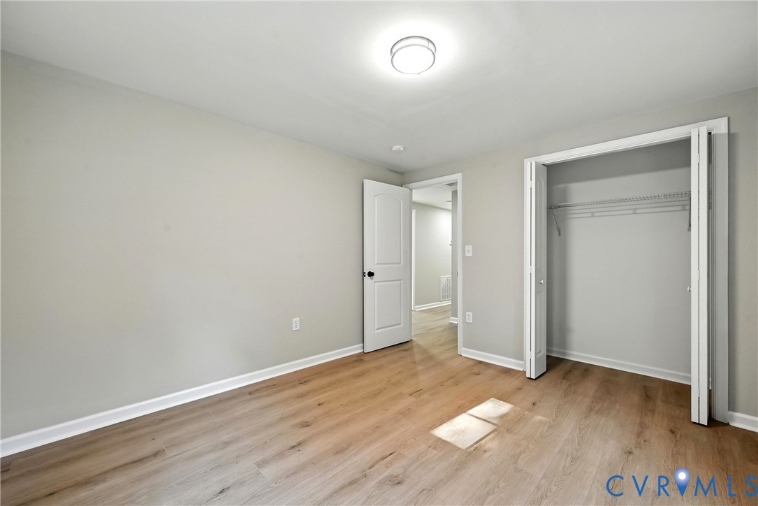 24611 Williamson Road Dinwiddie, VA 23841 - Photo 16 of 34 Unfurnished bedroom featuring light wood-type floo