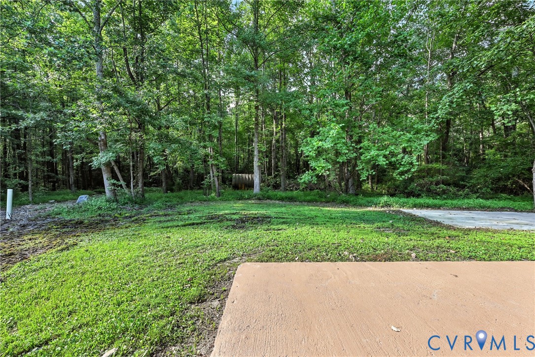 24611 Williamson Road Dinwiddie, VA 23841 - Photo 29 of 34 View of grassy yard featuring a wooded view