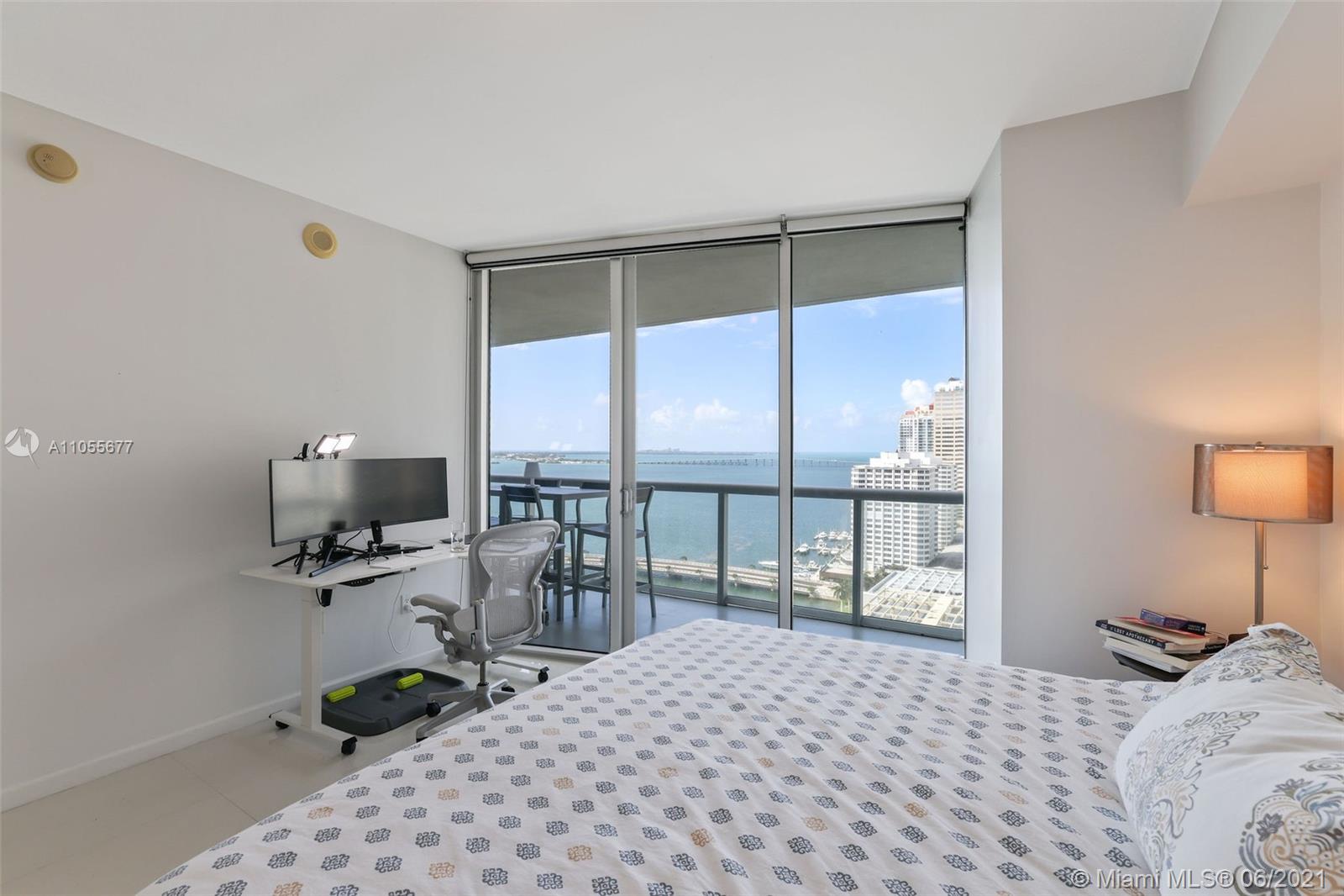 495 Brickell Avenue, Unit 2103 Miami, FL 33131 - Photo 13 of 43 a bedroom with a bed a large window and chair