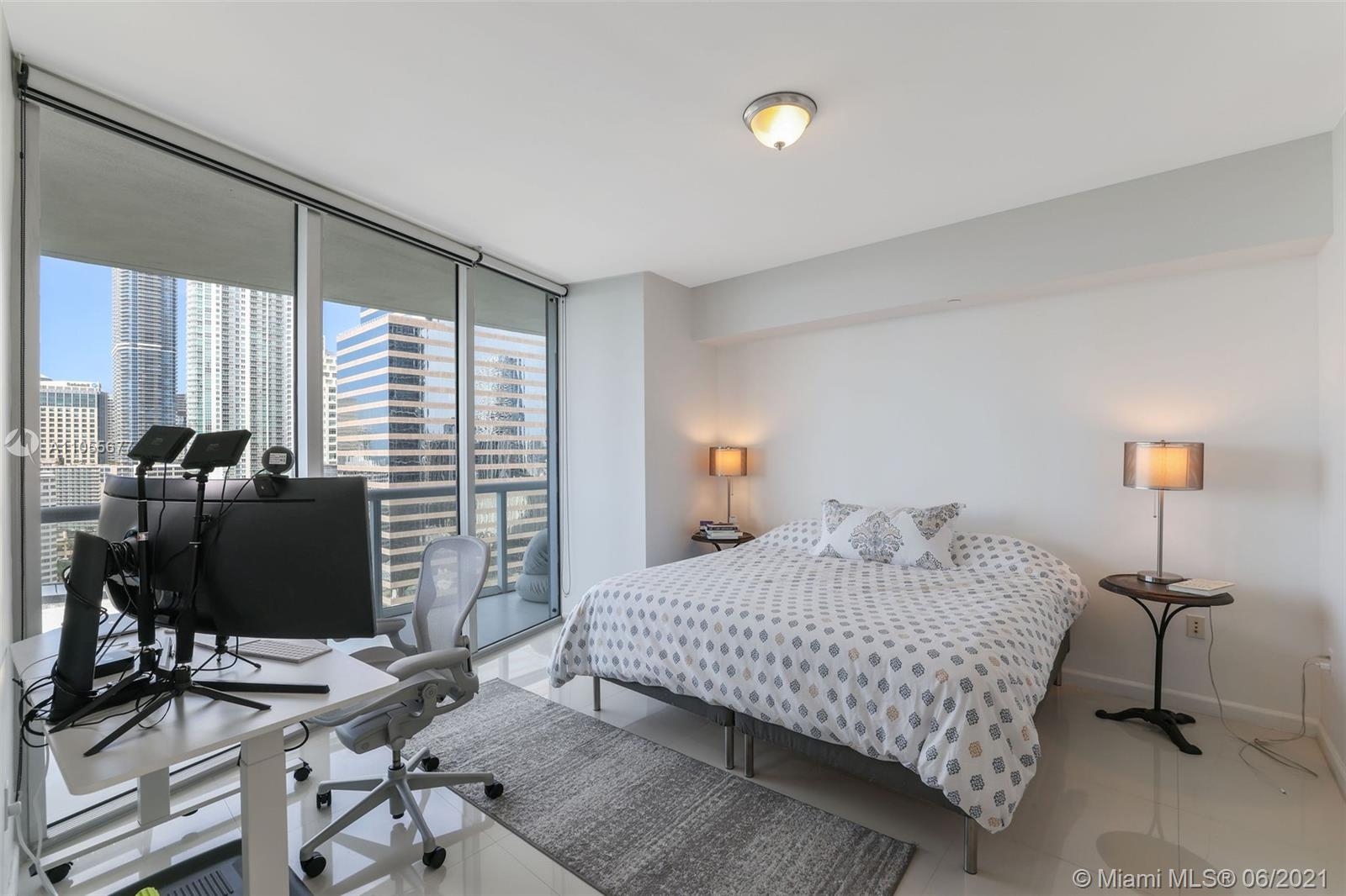 495 Brickell Avenue, Unit 2103 Miami, FL 33131 - Photo 14 of 43 a bedroom with a bed and a desk