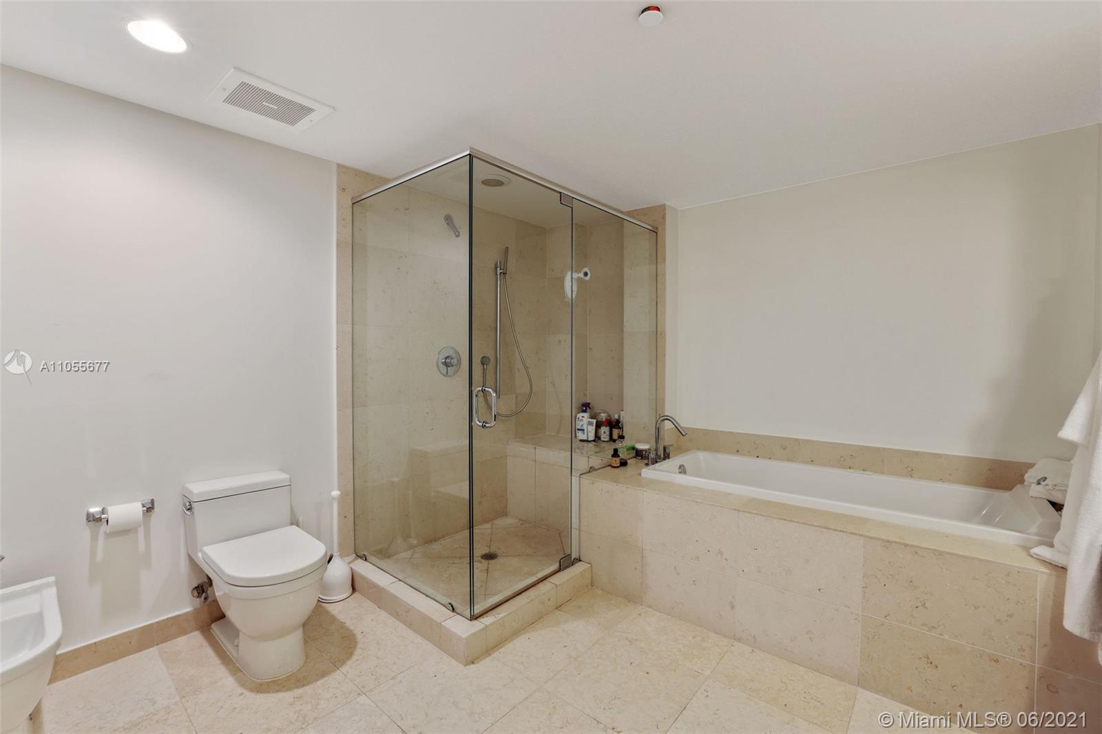 495 Brickell Avenue, Unit 2103 Miami, FL 33131 - Photo 15 of 43 a bathroom with a shower a toilet and a sink