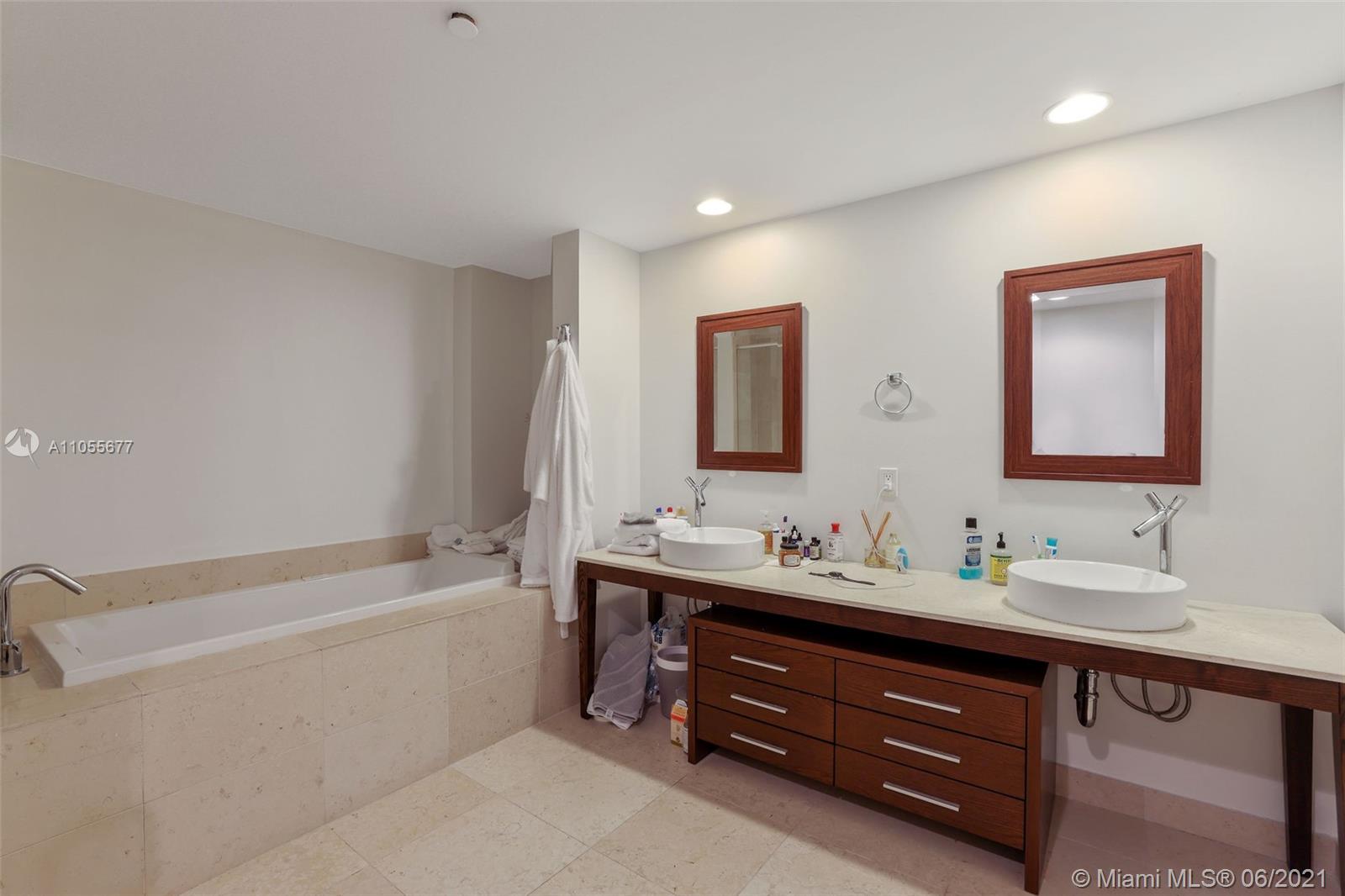 495 Brickell Avenue, Unit 2103 Miami, FL 33131 - Photo 16 of 43 a bathroom with a double vanity sink tub double and mirror