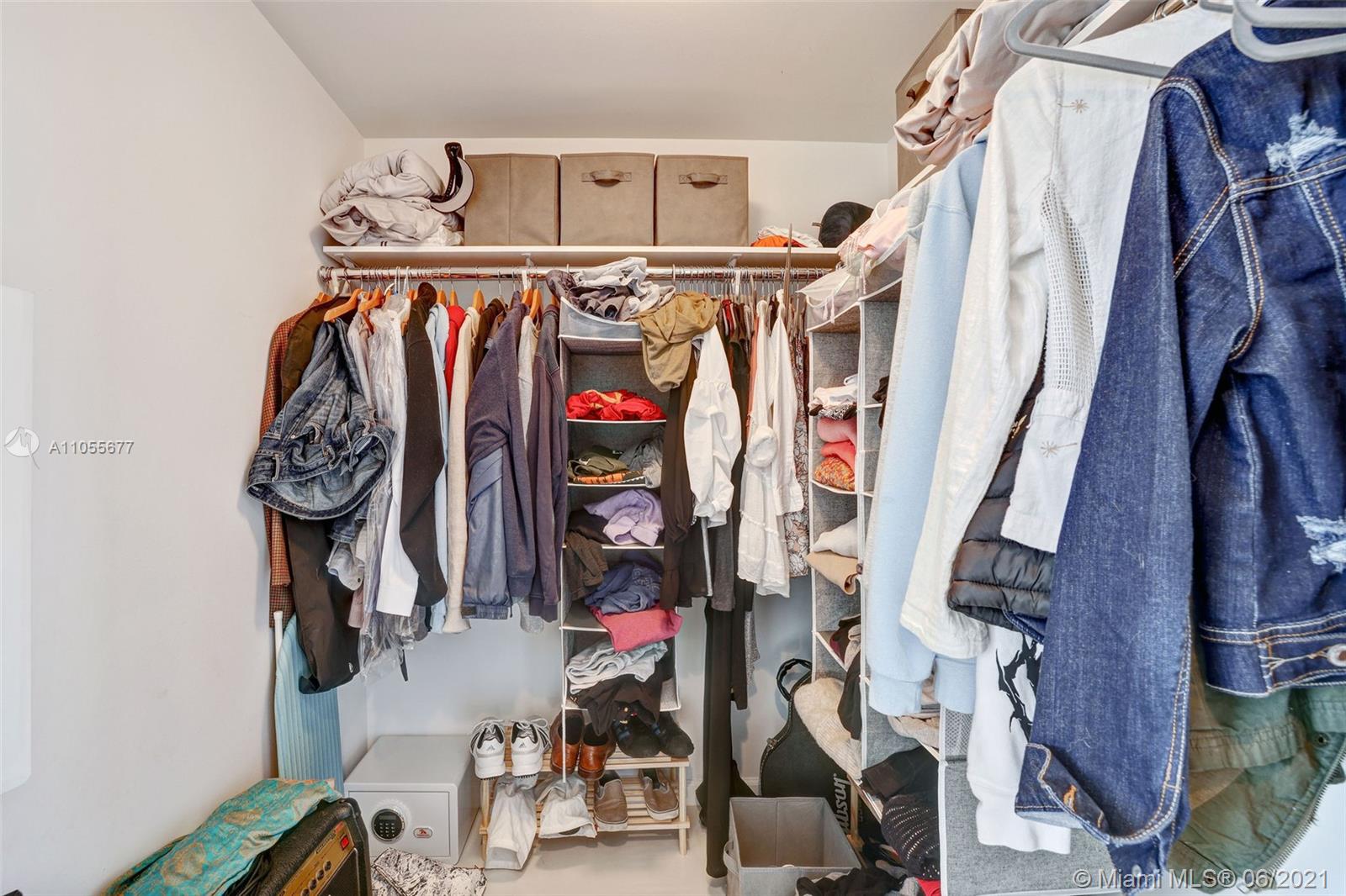 495 Brickell Avenue, Unit 2103 Miami, FL 33131 - Photo 17 of 43 a view of walk in closet with clothes and shoes