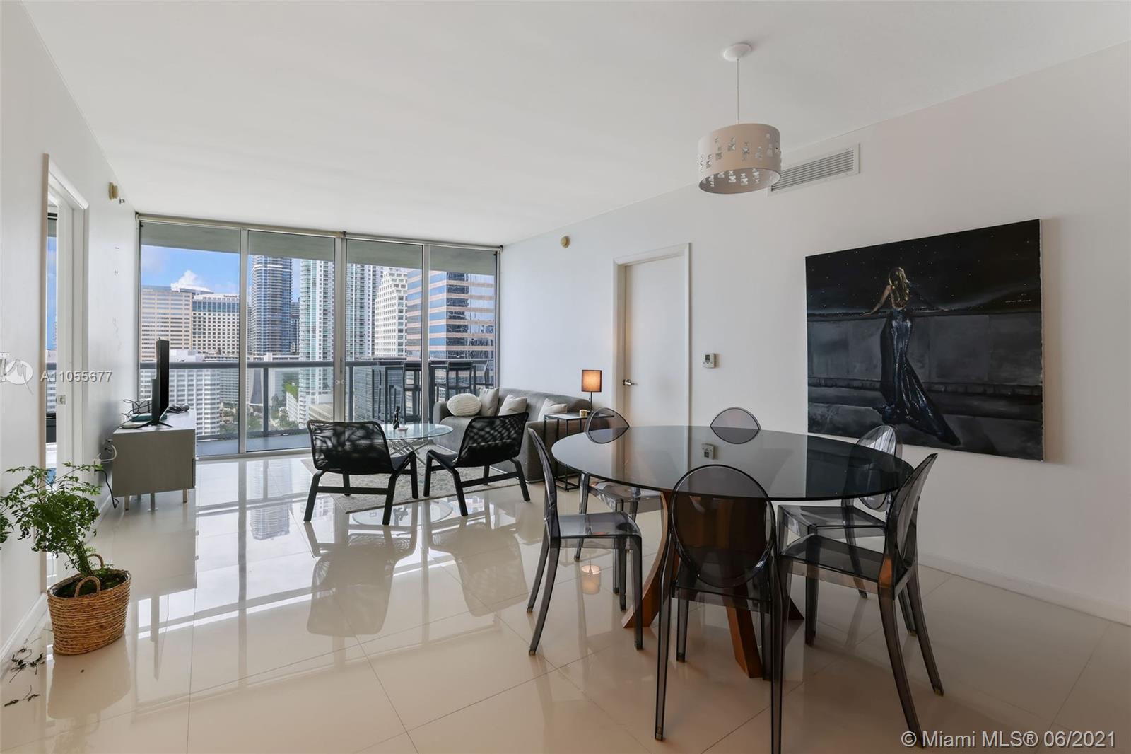 495 Brickell Avenue, Unit 2103 Miami, FL 33131 - Photo 19 of 43 a view of a dining room and livingroom with furniture wooden floor and a rug
