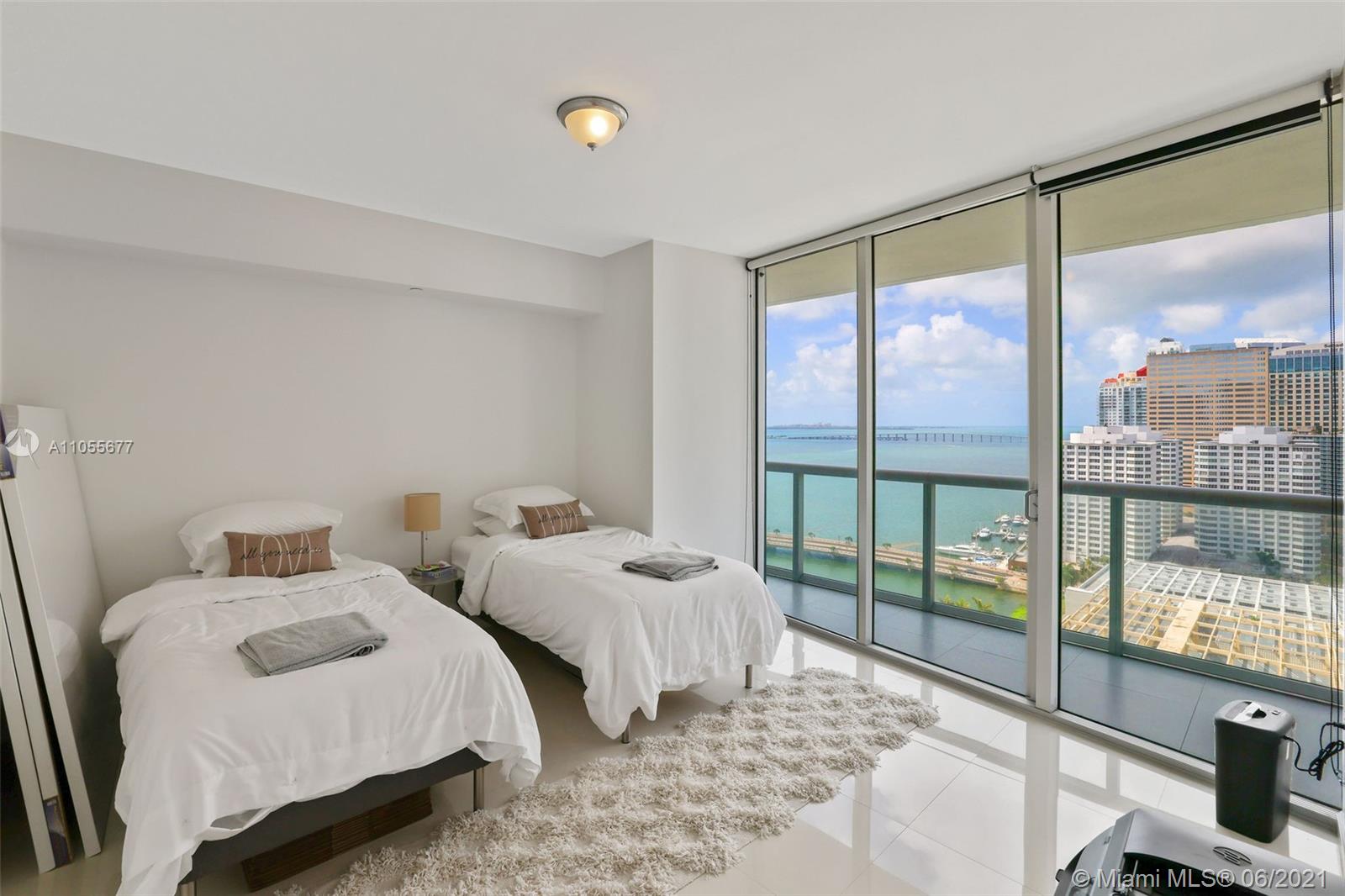 495 Brickell Avenue, Unit 2103 Miami, FL 33131 - Photo 20 of 43 a bedroom with two beds and glass door