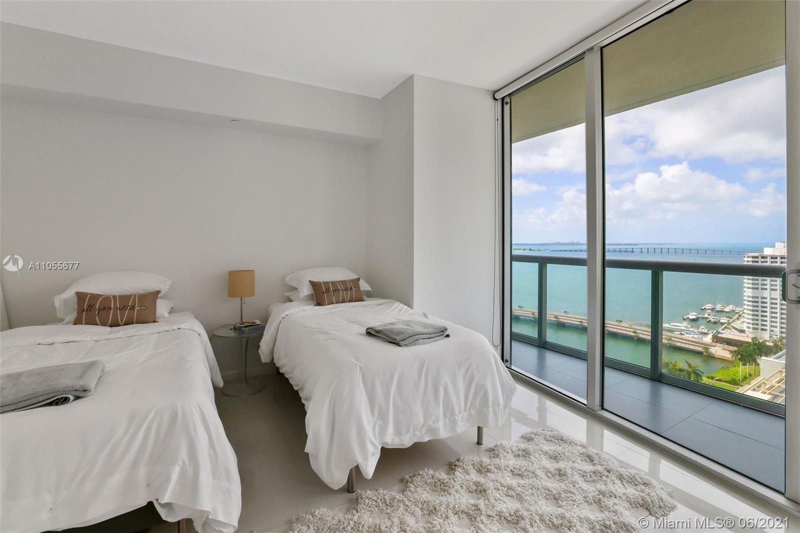 495 Brickell Avenue, Unit 2103 Miami, FL 33131 - Photo 21 of 43 a bedroom with two beds and next to a window