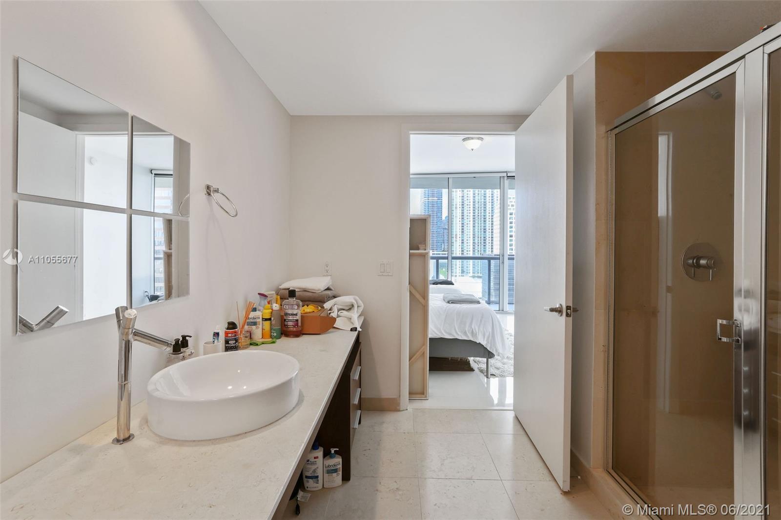 495 Brickell Avenue, Unit 2103 Miami, FL 33131 - Photo 22 of 43 a bathroom with a sink toilet and shower
