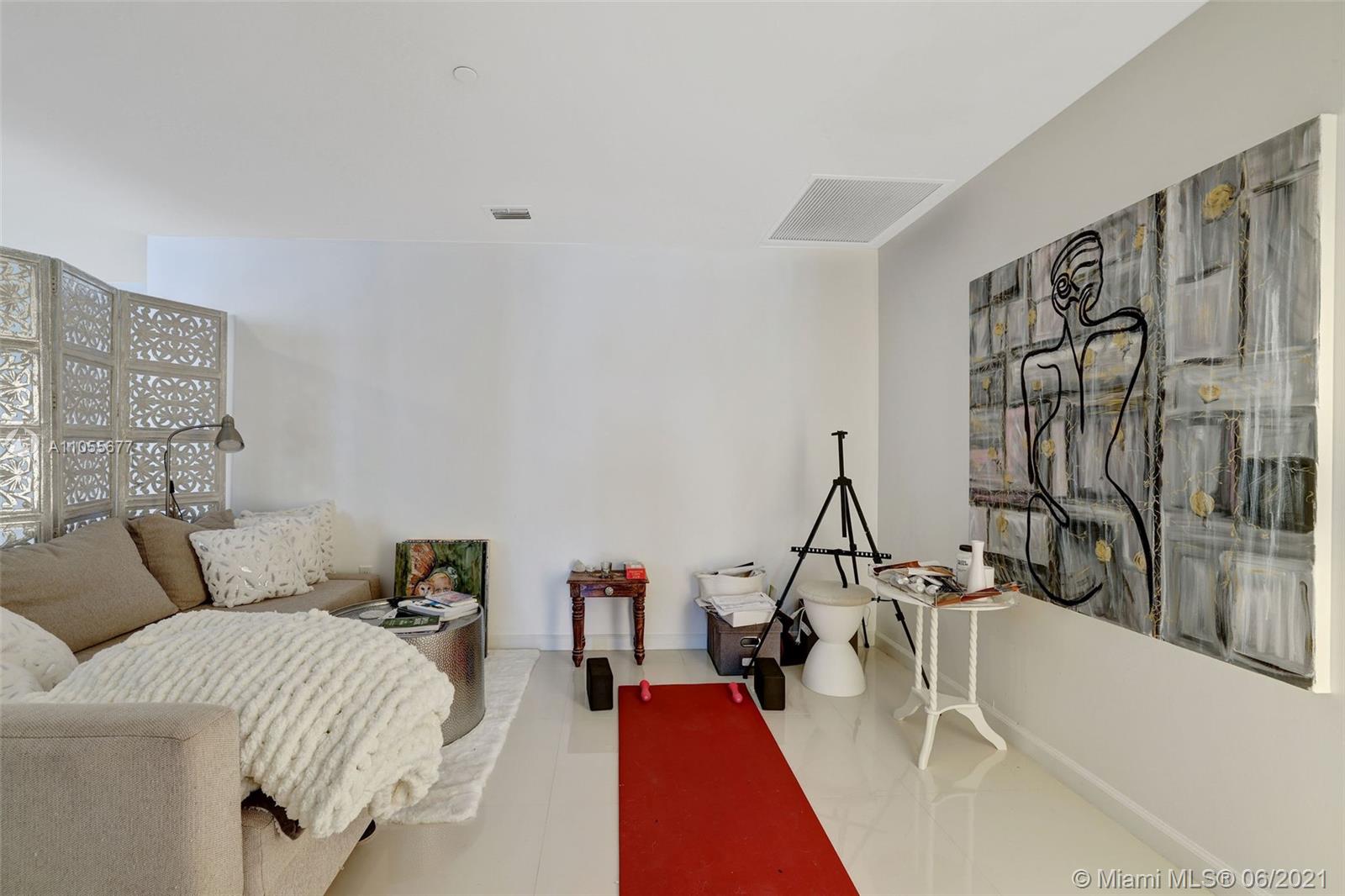 495 Brickell Avenue, Unit 2103 Miami, FL 33131 - Photo 24 of 43 a living room with furniture a rug and white walls