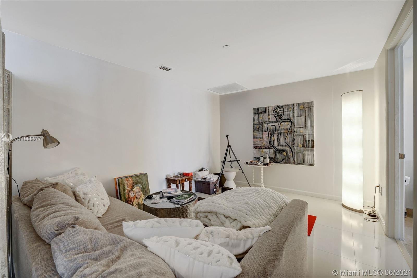 495 Brickell Avenue, Unit 2103 Miami, FL 33131 - Photo 25 of 43 a living room with furniture and a window