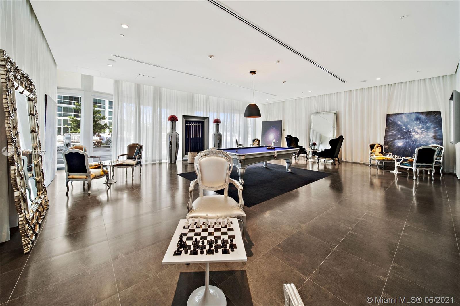 495 Brickell Avenue, Unit 2103 Miami, FL 33131 - Photo 37 of 43 a living room with furniture a rug kitchen view and a large window