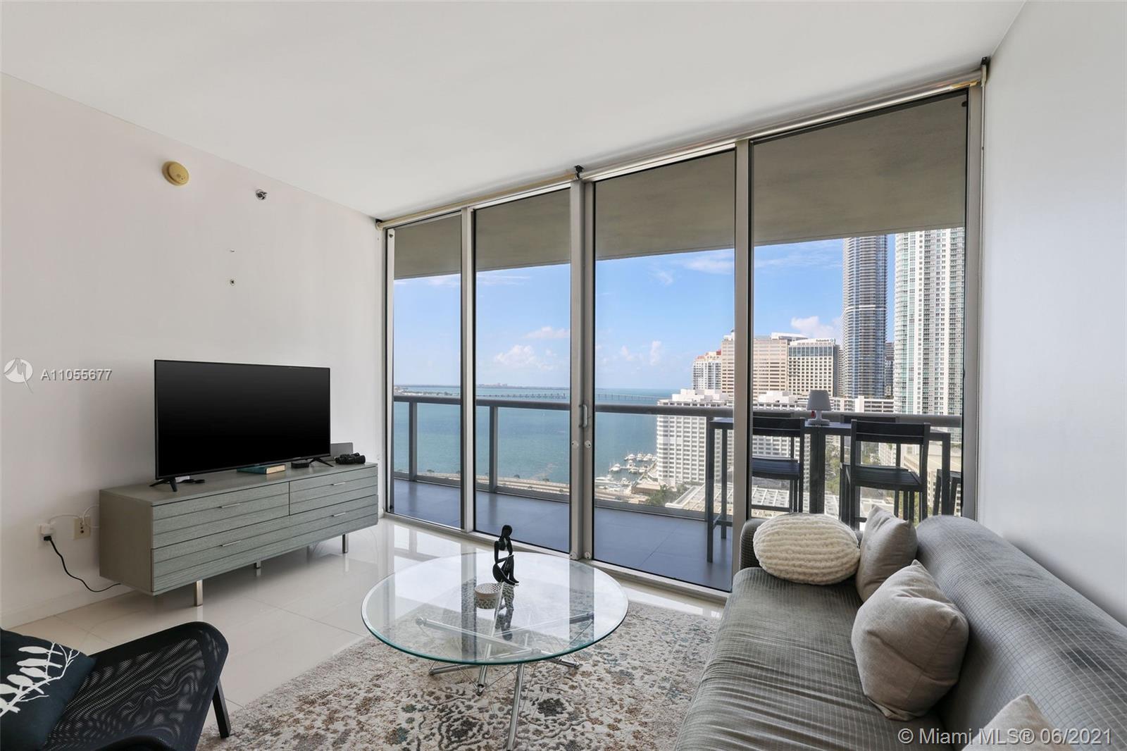 495 Brickell Avenue, Unit 2103 Miami, FL 33131 - Photo 5 of 43 a living room with furniture and a flat screen tv
