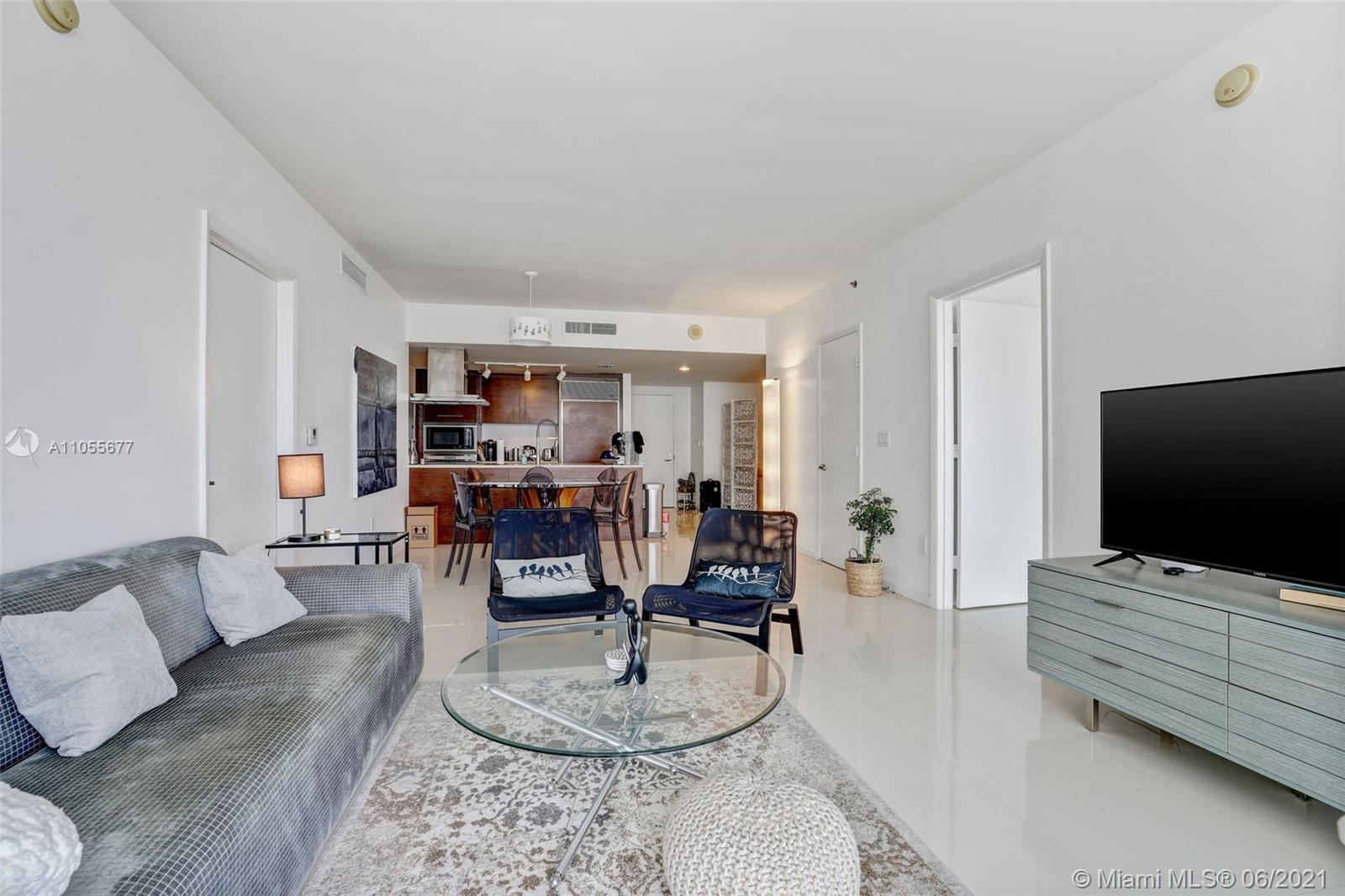 495 Brickell Avenue, Unit 2103 Miami, FL 33131 - Photo 8 of 43 a living room with furniture and a flat screen tv