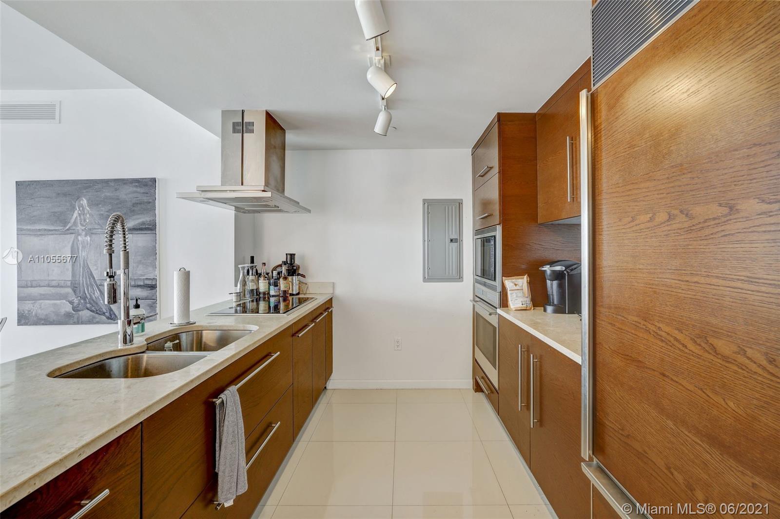 495 Brickell Avenue, Unit 2103 Miami, FL 33131 - Photo 10 of 43 a kitchen with cabinets and sink