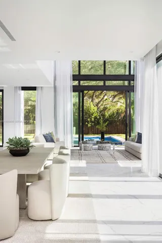 a living room with furniture and large windows