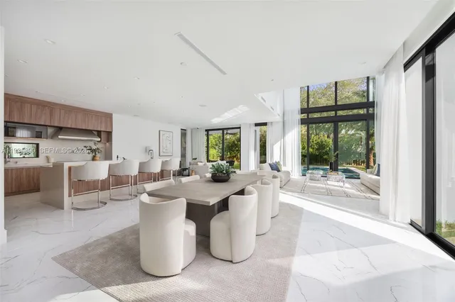 a large white kitchen with a large window