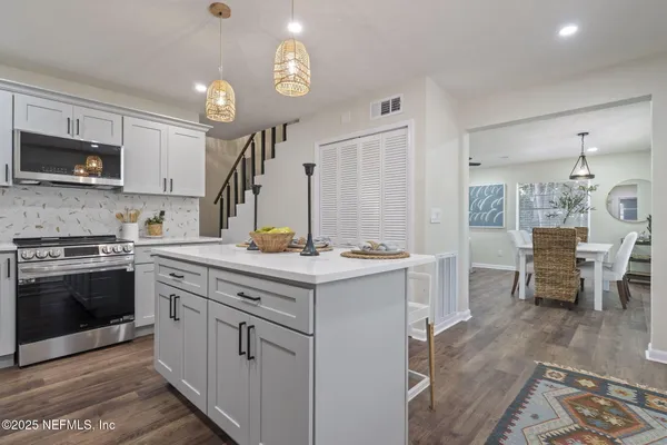 a kitchen with a sink cabinets and stainless steel appliances