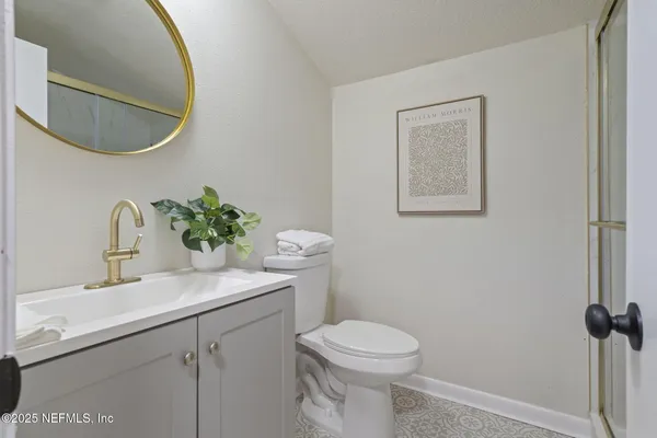 a bathroom with a sink mirror vanity and toilet