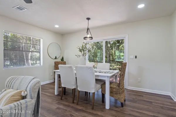 a view of a dining room with furniture window and wooden floor