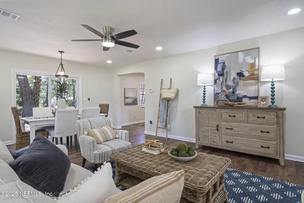 a living room with furniture and a wooden floor