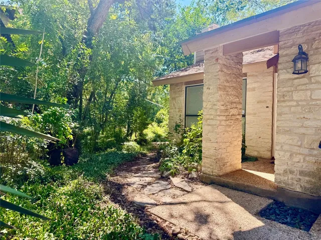 a view of a pathway besides a house