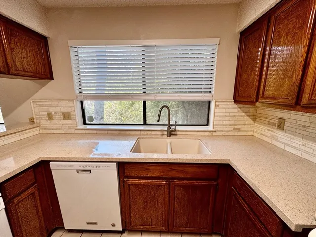 a kitchen with a sink and a window