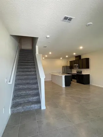 a view of kitchen with kitchen island microwave and stove