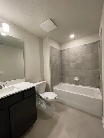 a bathroom with a sink a toilet and bathtub