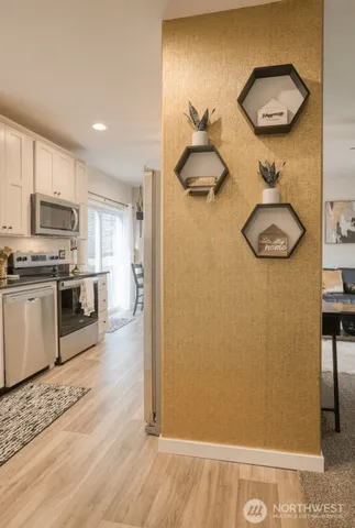 a kitchen with stainless steel appliances granite countertop a refrigerator a stove and a sink