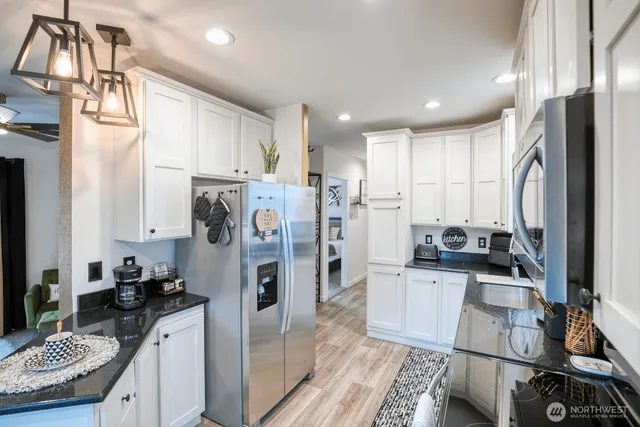 a kitchen with stainless steel appliances granite countertop a refrigerator stove and sink