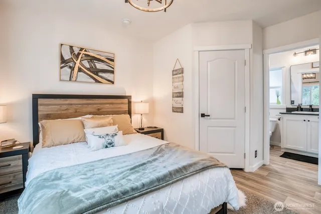 a bedroom with a bed and wooden floor