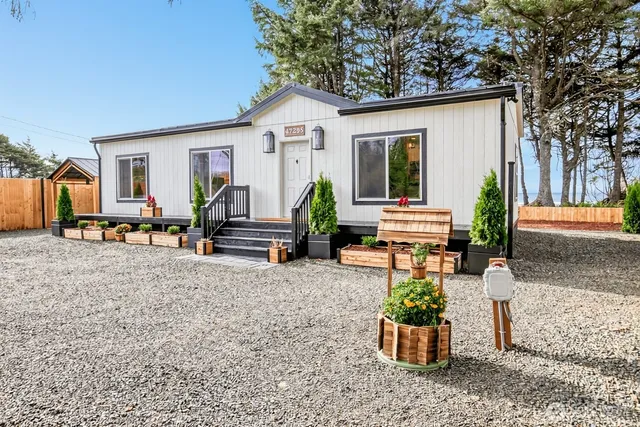 a view of a house with backyard and sitting area