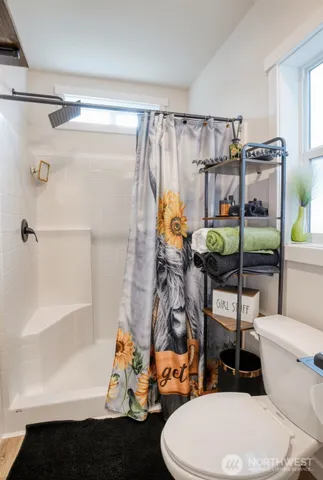 a bathroom with a toilet and a shower