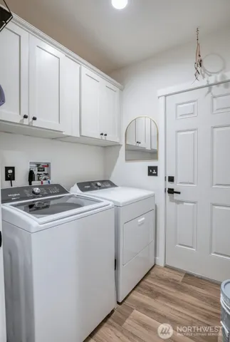 a utility room with sink dryer and washer