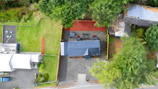 an aerial view of a house with a yard