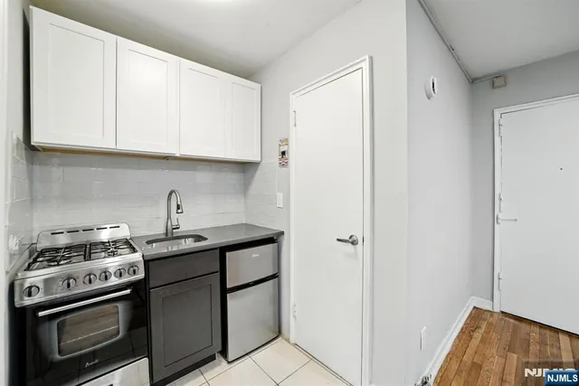 a kitchen with stainless steel appliances granite countertop a sink and a stove