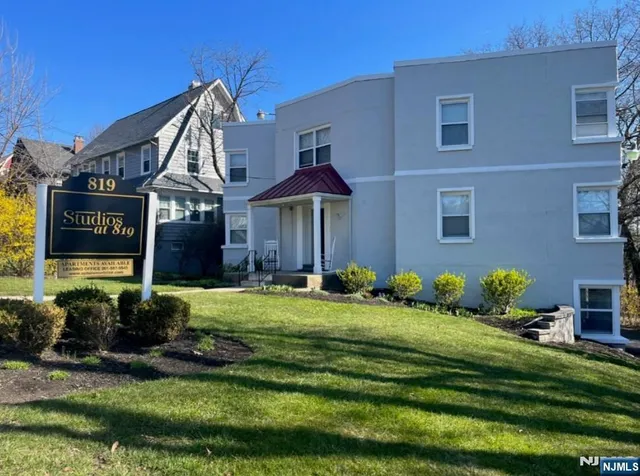 a front view of a house with a yard table and chairs