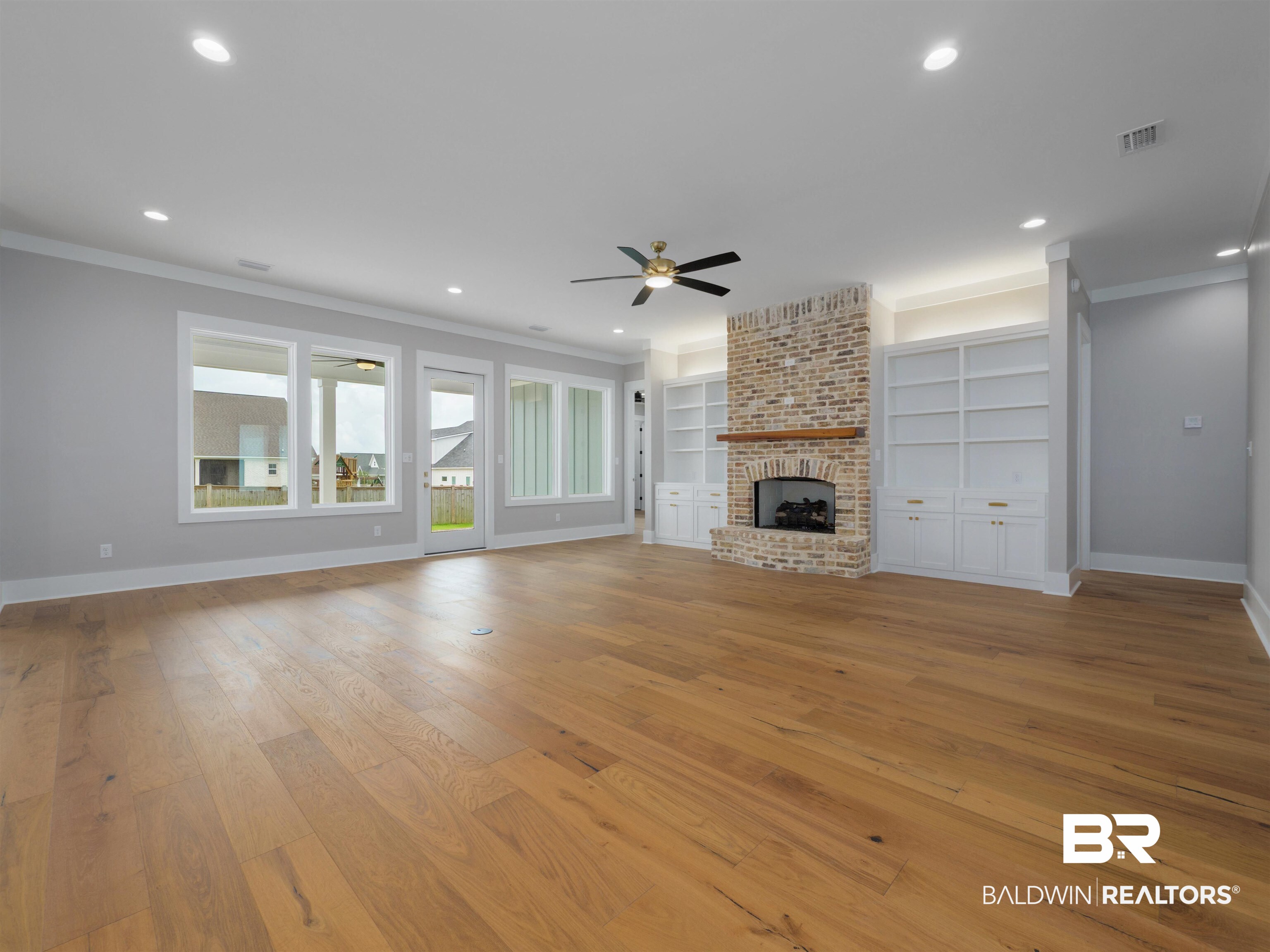 10912 Catania Avenue Fairhope, AL 36532 - Photo 9 of 54 The living room with built-in bookcases and brick fireplace