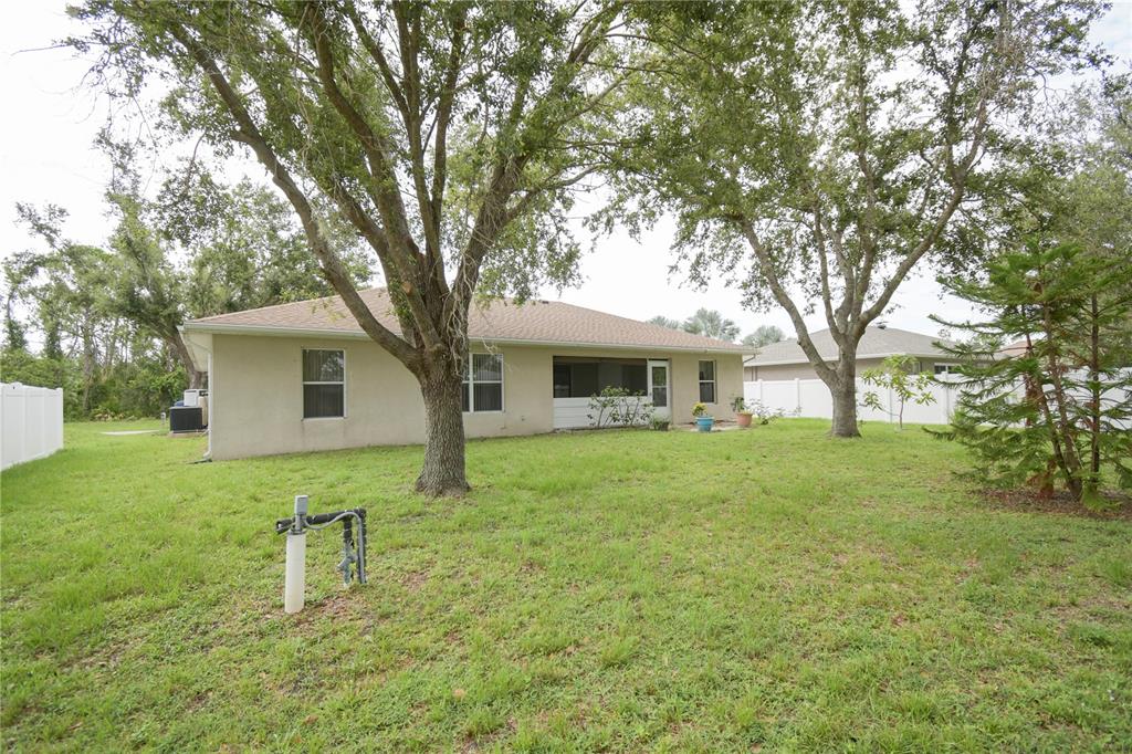 4913 Cromey Road North Port, FL 34288 - Photo 26 of 36 a front view of a house with a garden and trees