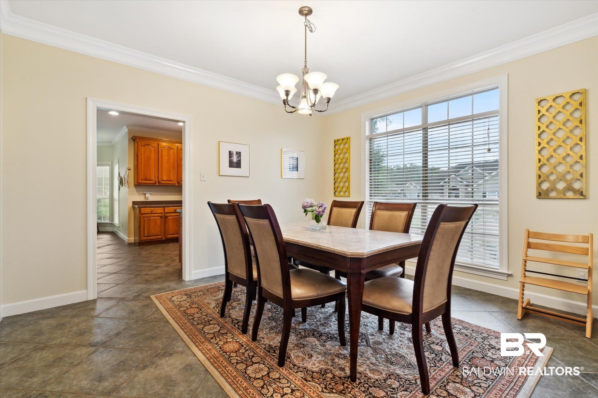 1561 William Dunn Way Mobile, AL 36695 - Photo 6 of 28 Tiled dining space with an inviting chandelier and ornamental molding