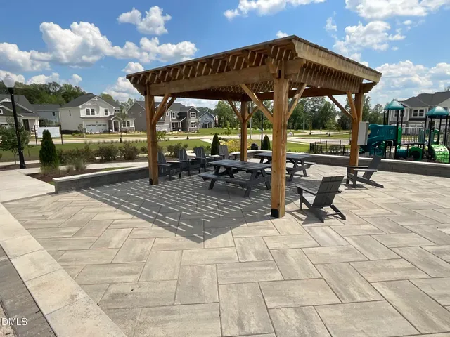 a view of a patio with a table and chairs under an umbrella