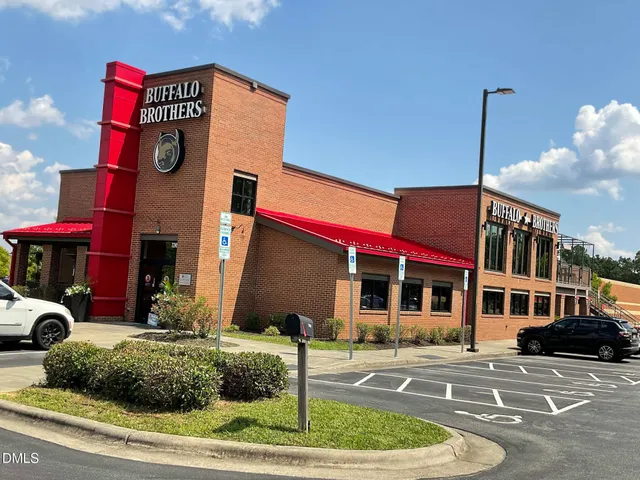 a front view of a building with garden
