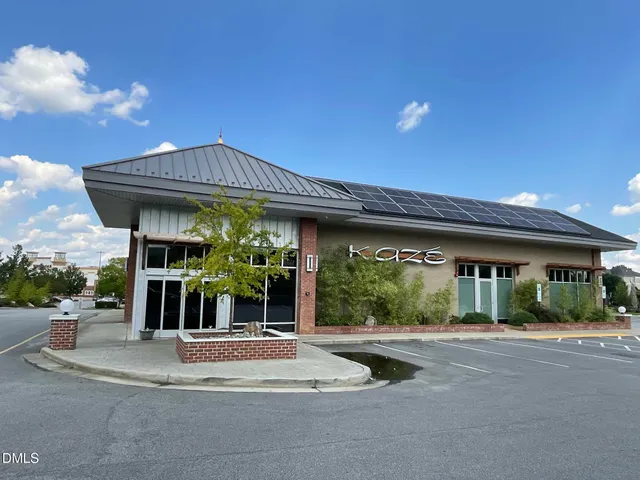 a view of a house with sitting area and garden