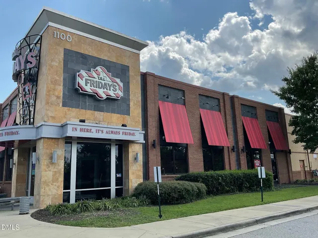 a view of multi story residential apartment building with entryway