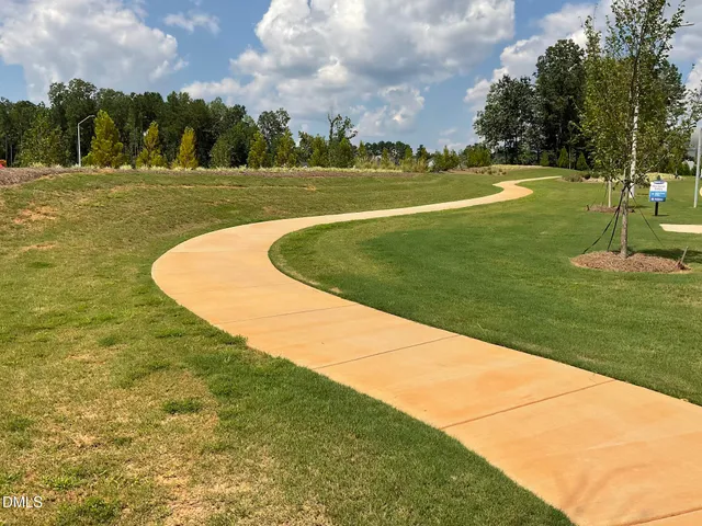 a view of a swimming pool with a yard